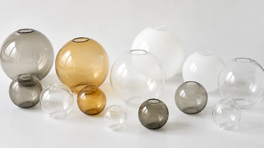 Borosilicate glass globe shades in smoked, amber, clear, and frosted finishes for cluster pendant lighting