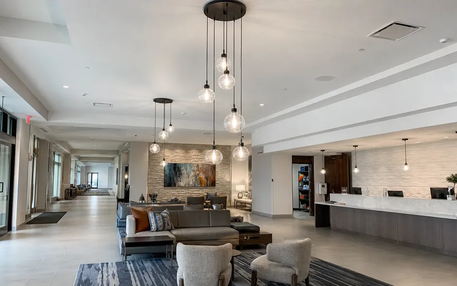 Cluster pendant lighting installed in a hotel lobby setting showing varied drop heights
