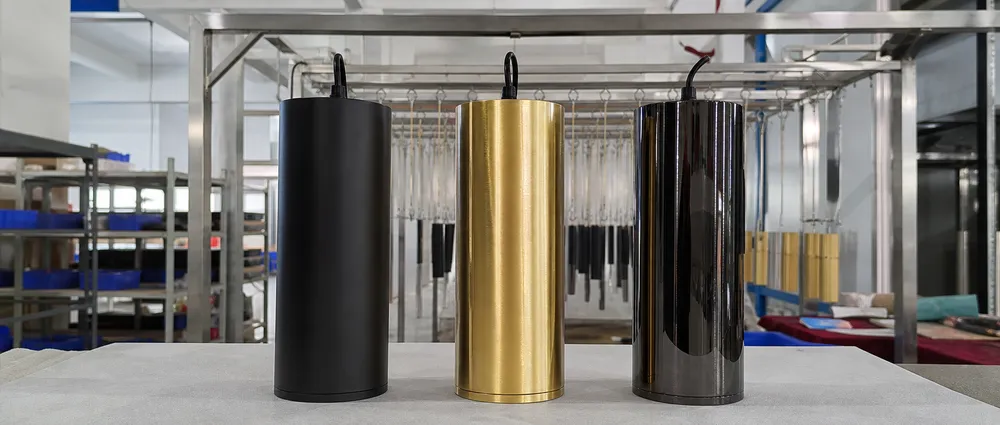 Cylinder pendant lighting finish options — matte black, brushed gold, and PVD titanium black side by side