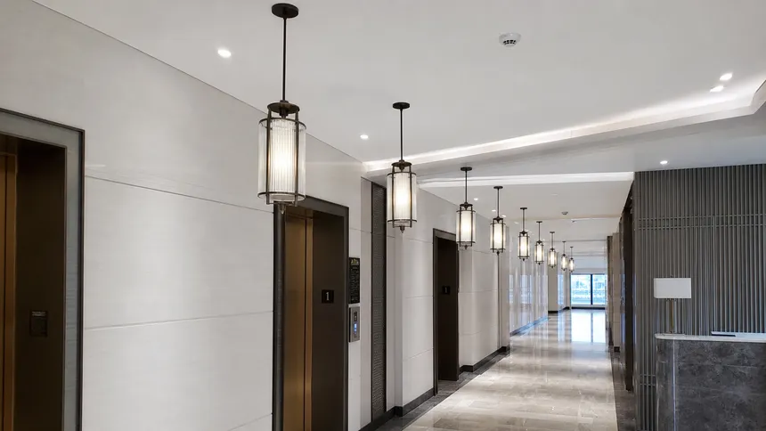 Entryway pendant lighting installed in a hotel lobby corridor showing batch deployment across multiple fixtures