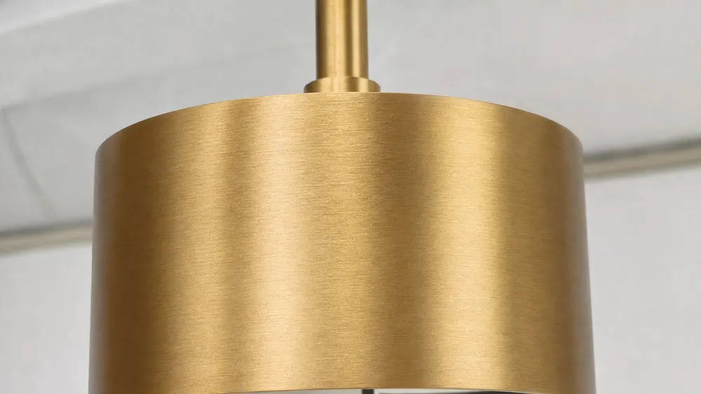 Brushed gold pendant lighting finish showing directional texture and warm yellow-gold tone