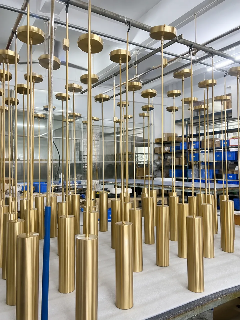 Gold pendant lighting fixtures showing consistent PVD finish across a production batch