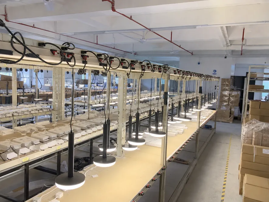 Pendant luminaires undergoing 100% aging burn-in test on powered racks before shipment