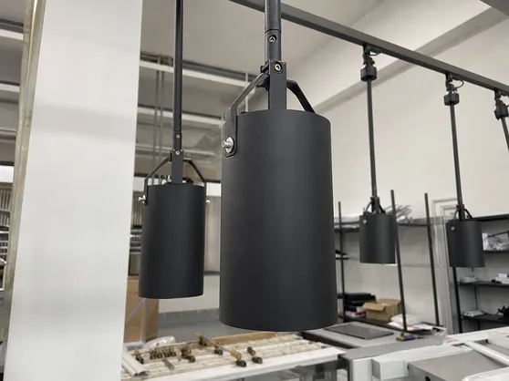 Industrial pendant lighting with exposed hardware and matte black finish