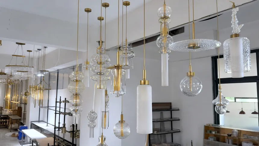 Gold pendant lighting and custom glass cluster configurations for high-end interior design projects