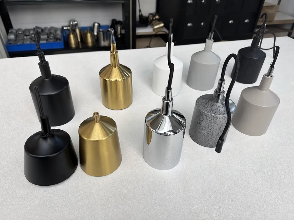 Pendant lighting finish samples showing matte black, brushed gold, chrome, and powder-coated options