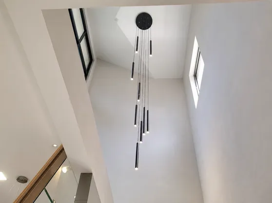 Staircase pendant lighting designed for high-ceiling long-drop installations
