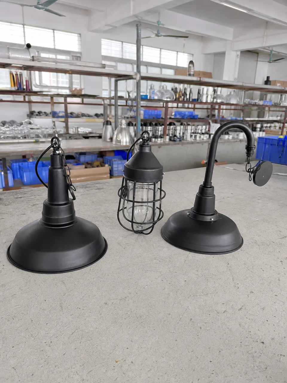 Industrial pendant lighting collection featuring cage, dome, and pipe arm configurations in matte black finish