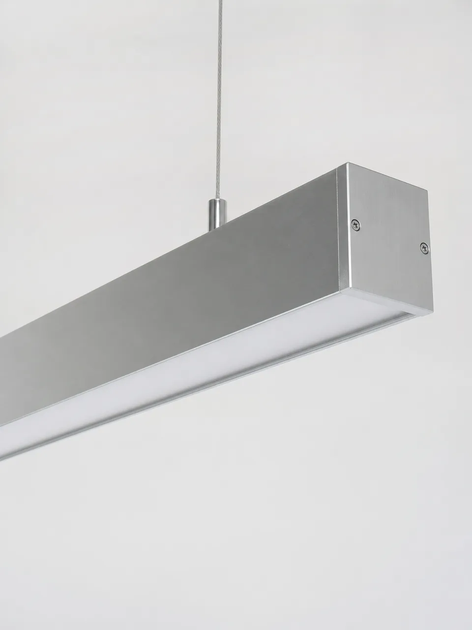 Integrated LED pendant lighting fixture showing precision-machined aluminum housing and diffuser detail