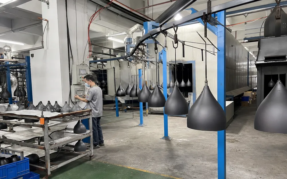 Automated powder coat line producing modern pendant lighting housings at consistent 60-80μm thickness