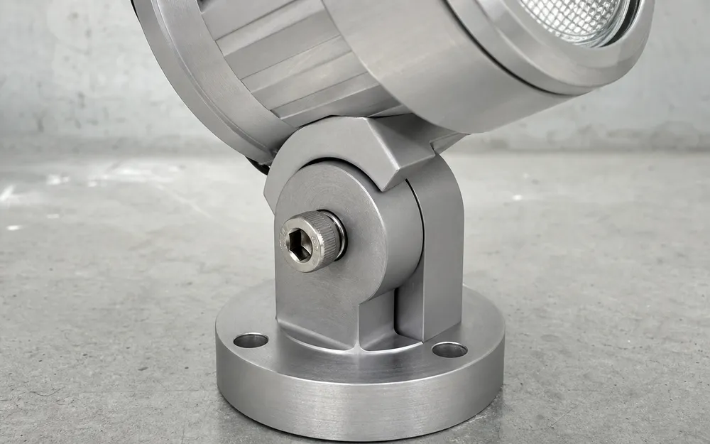 Close-up of machined pivot seat with stainless steel tension screw on adjustable spotlight