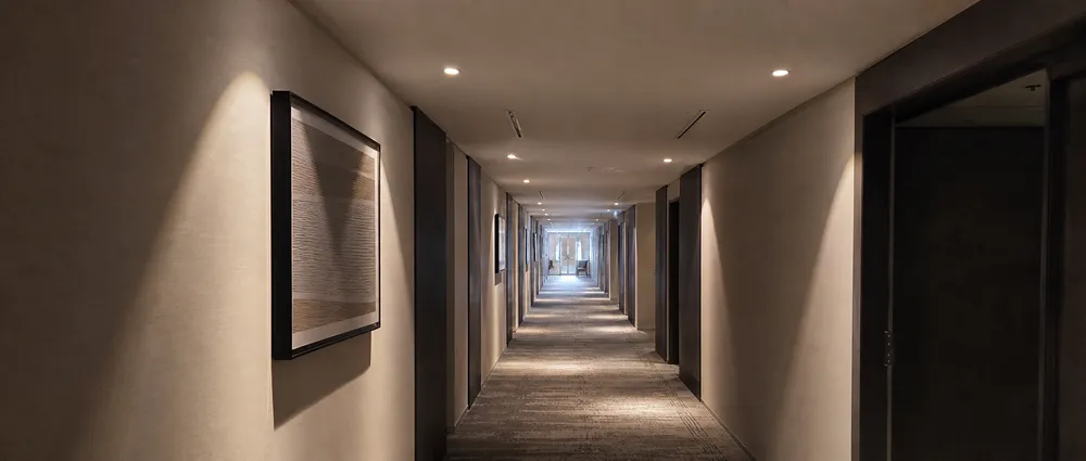 Ceiling spotlights installed in hotel corridor with warm 3000K illumination