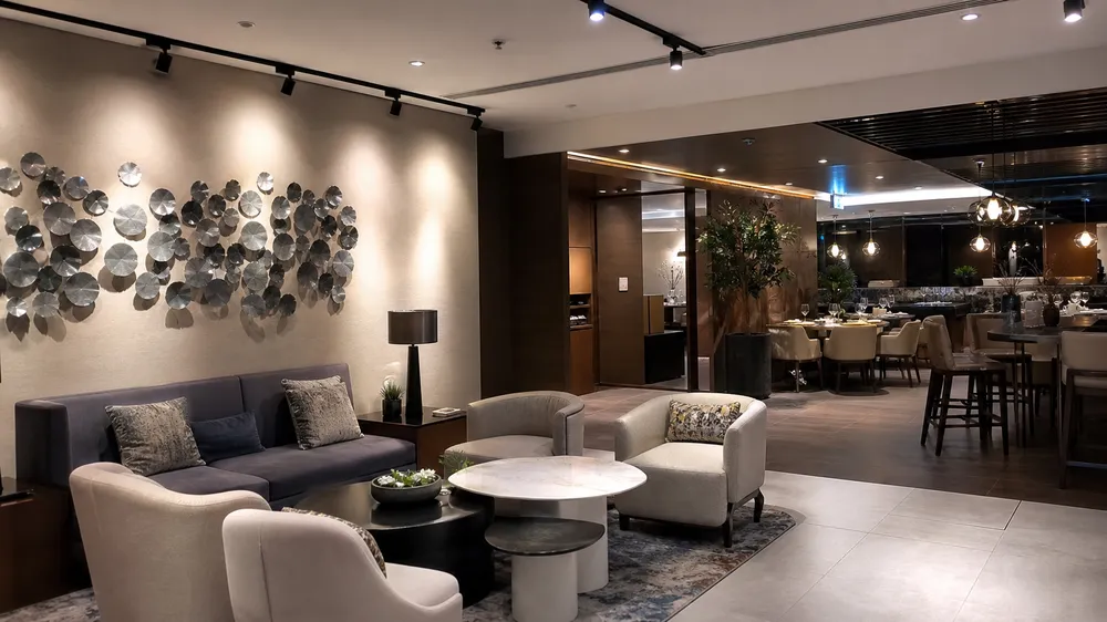 Hotel lobby and restaurant interior with track lighting providing warm ambient illumination and accent lighting