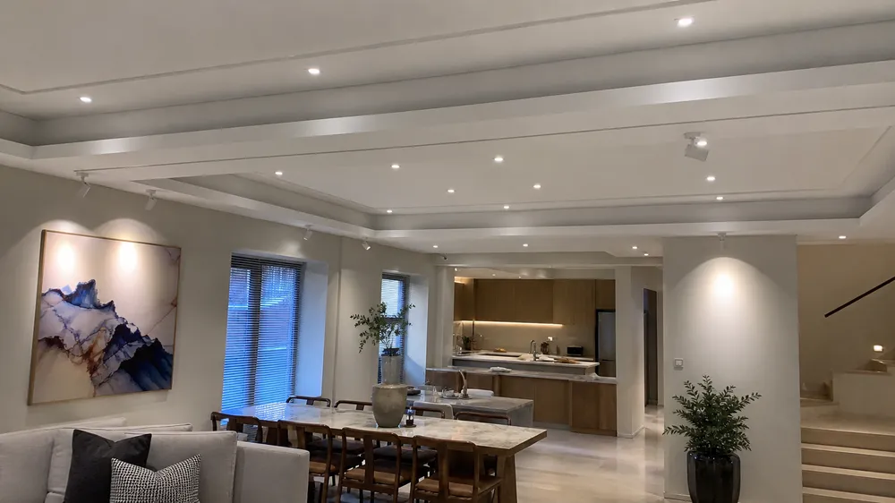 Luxury villa interior with recessed spotlights and adjustable ceiling spotlights as architectural lighting layer