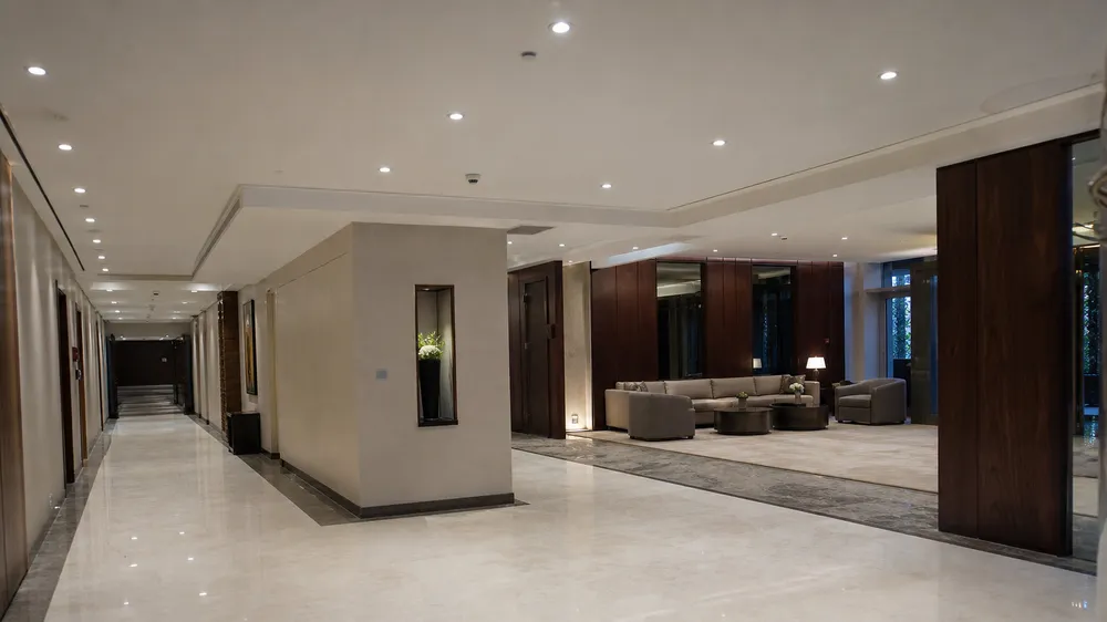 Recessed spotlights installed in a hotel corridor and lobby setting