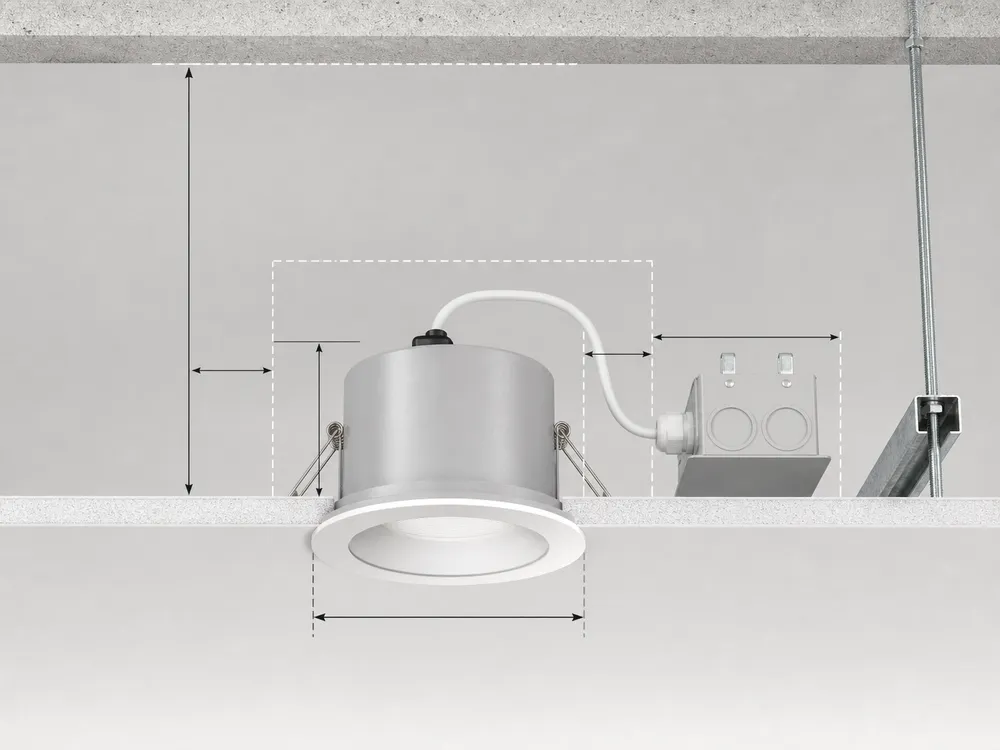 Recessed spotlight installation geometry showing ceiling cutout diameter, housing depth, and void clearance requirements