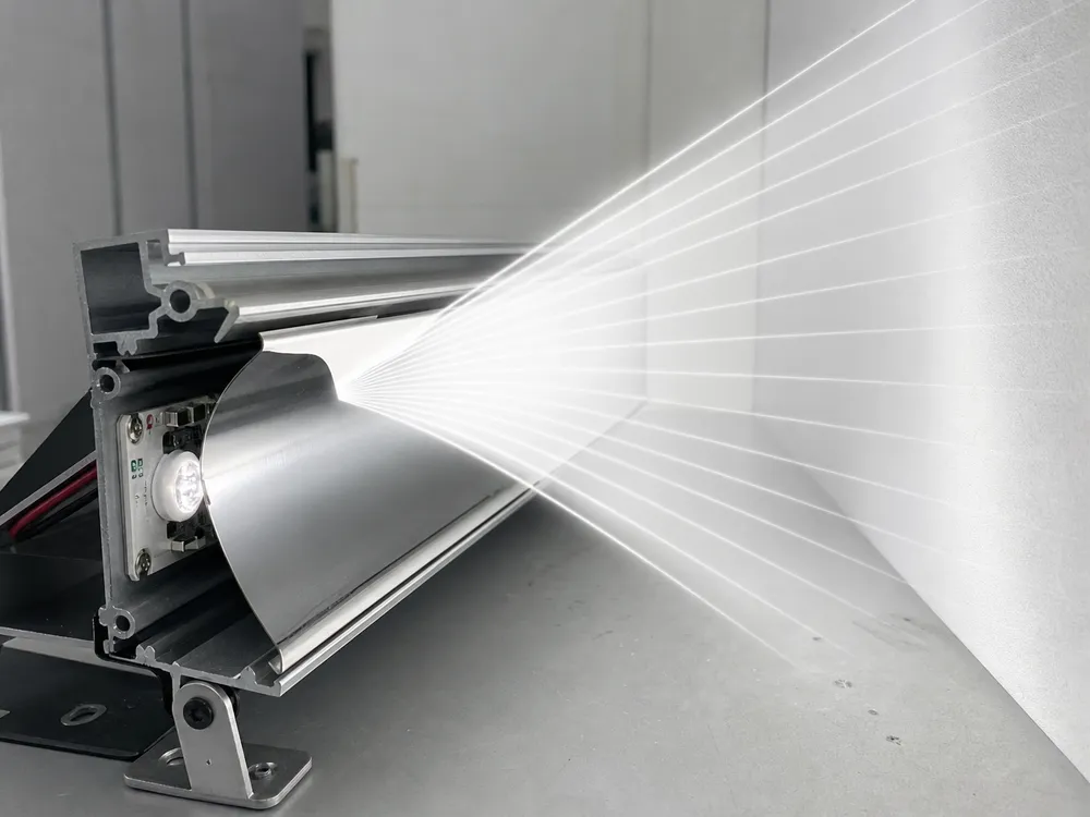 Asymmetric reflector profile inside wall washer fixture showing calculated beam geometry