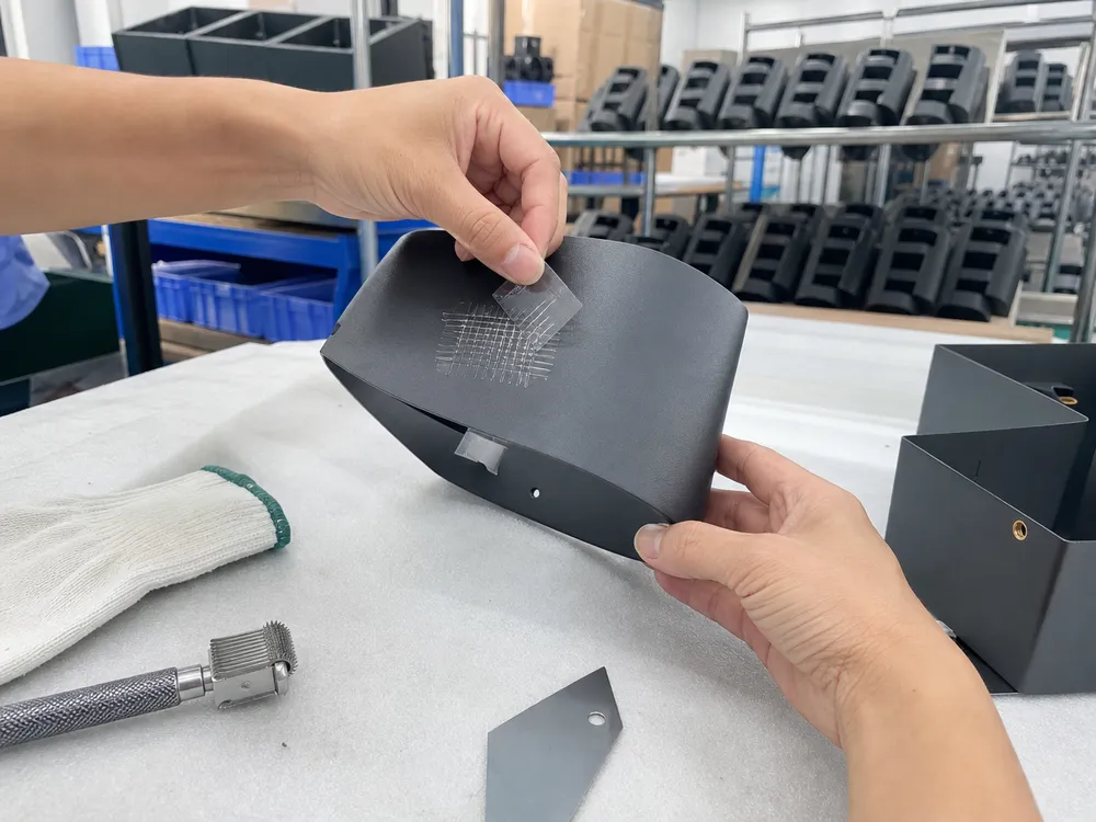 Cross-cut adhesion testing on powder coated wall sconce finish during production quality control