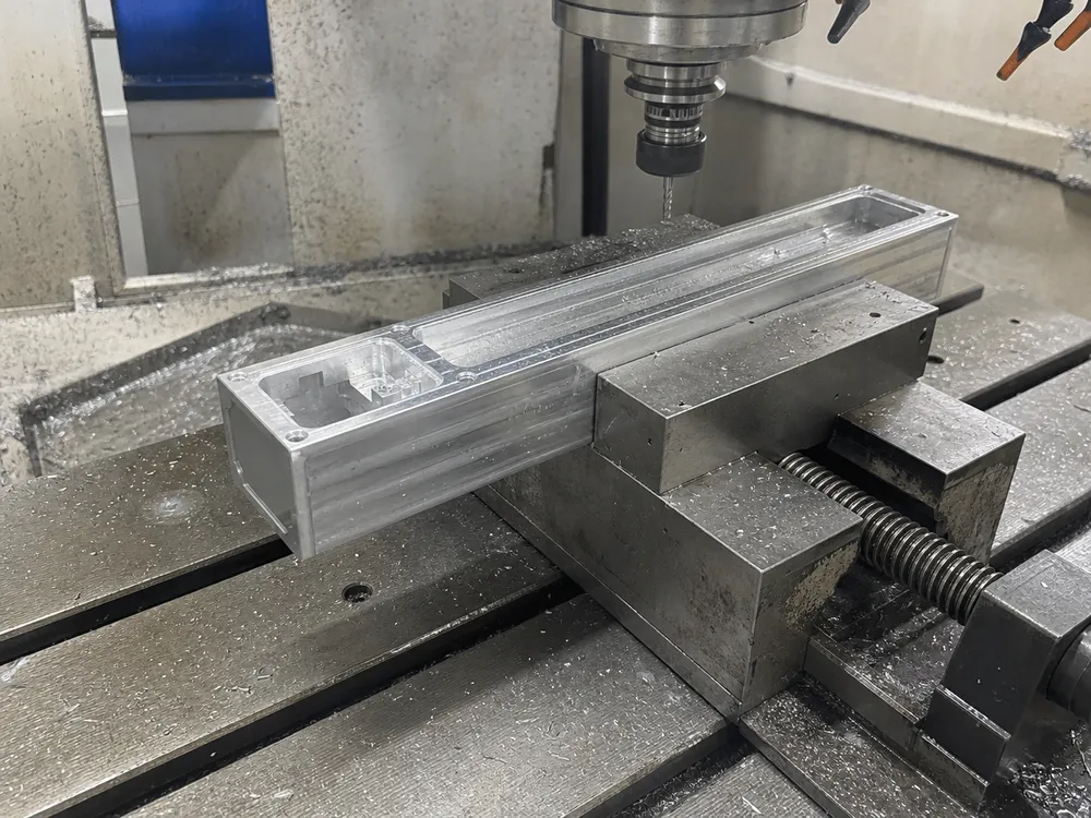 CNC machining of ADC12 aluminum linear wall light housing showing precision mounting face