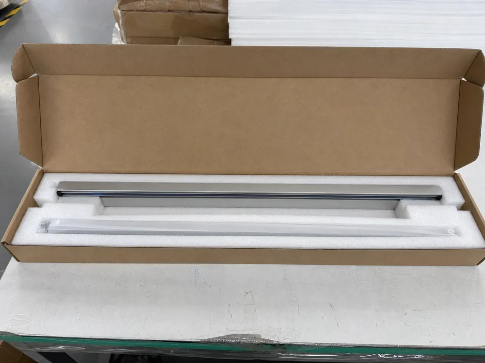 Foam-lined inner packaging showing formed channel protecting linear wall light bar profile during shipping