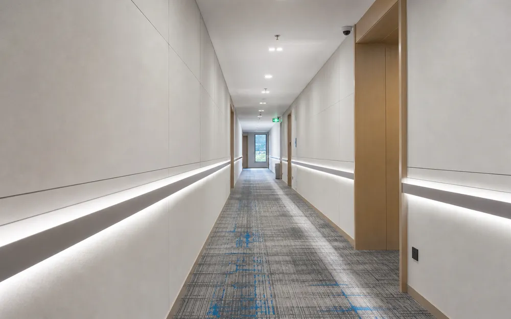 Linear wall lighting providing uniform corridor accent illumination in a hospitality setting
