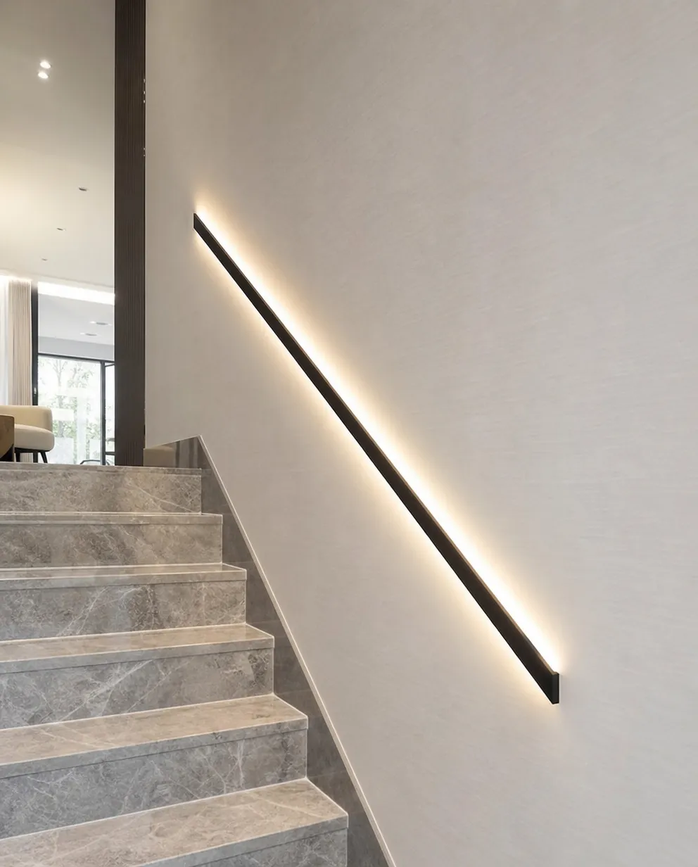 Linear wall lighting on luxury residential staircase wall showing premium finish quality at close range