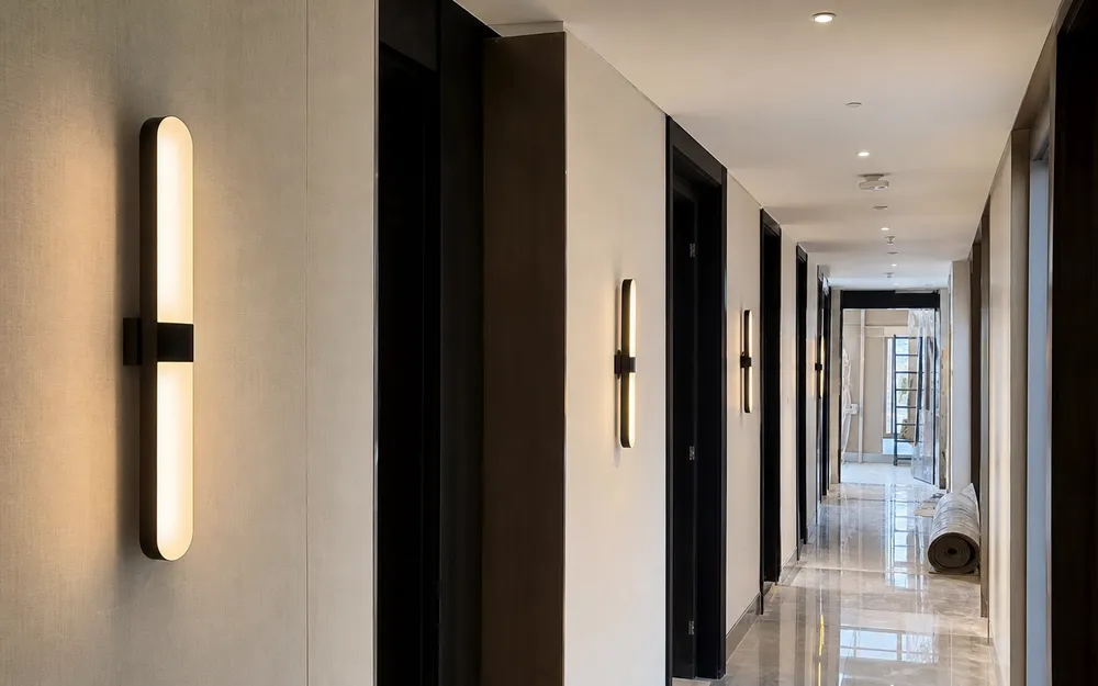 Modern wall sconces installed in hotel corridor for hospitality fit-out project