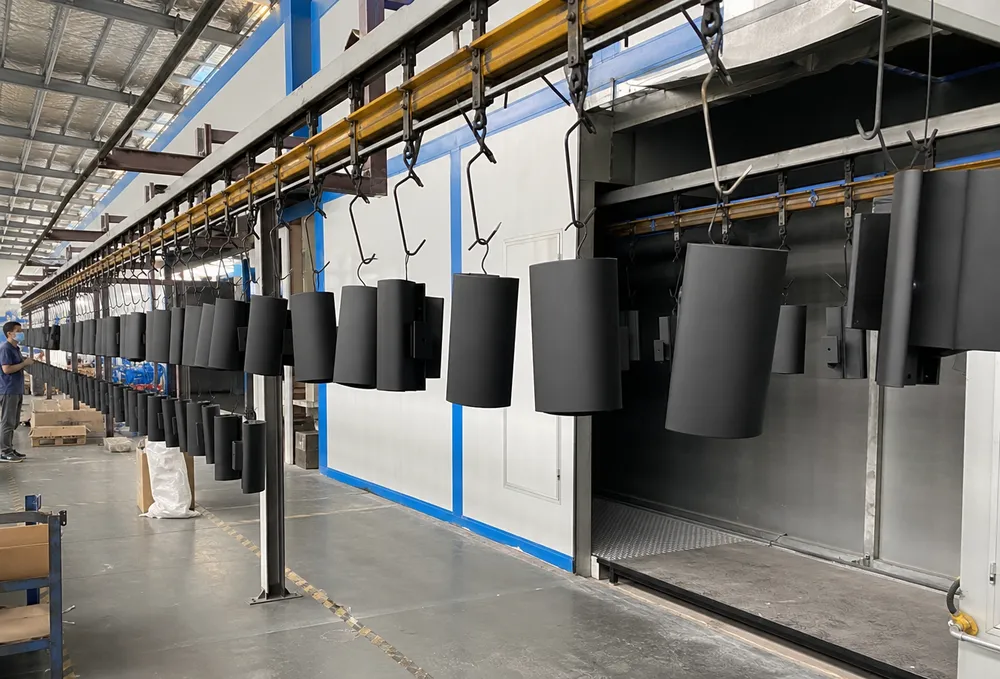 Automated powder coating line applying consistent matte black finish to modern wall lighting housings