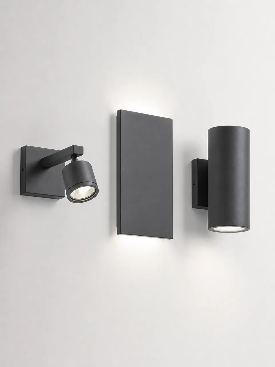 Three modern wall lighting form factors: arm-mounted sconce, flush-back panel, and projecting cylinder