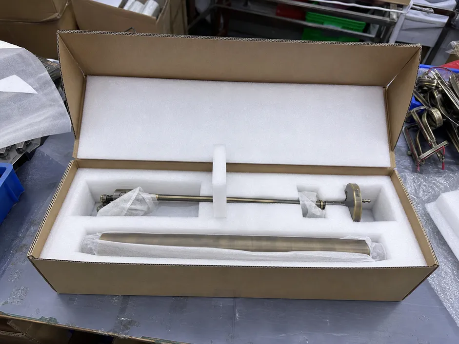 EPE foam-lined inner carton with picture light arm secured for ocean freight shipping