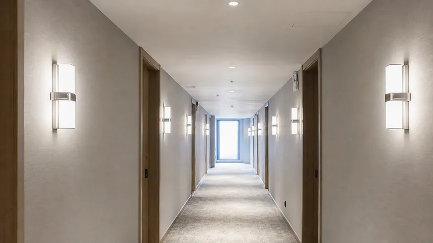 Wall sconce lighting installed in hotel corridor showing batch consistency across multiple fixtures