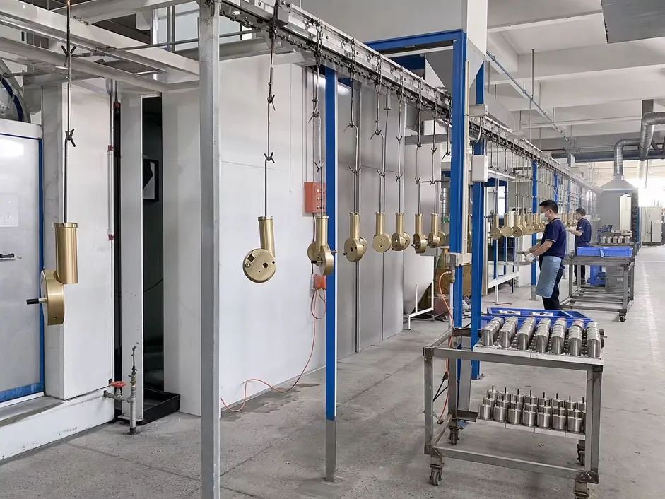 Automated powder coating line for wall sconce surface finishing