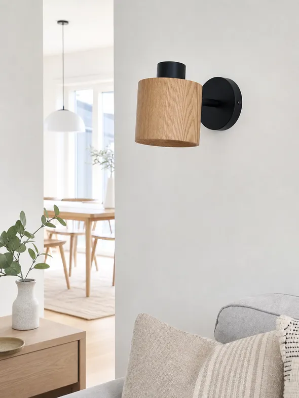 Natural oak wall light with matte black hardware in Scandinavian-style residential interior
