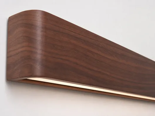 Walnut wood grain showing rich color and distinctive figure for premium wall lighting